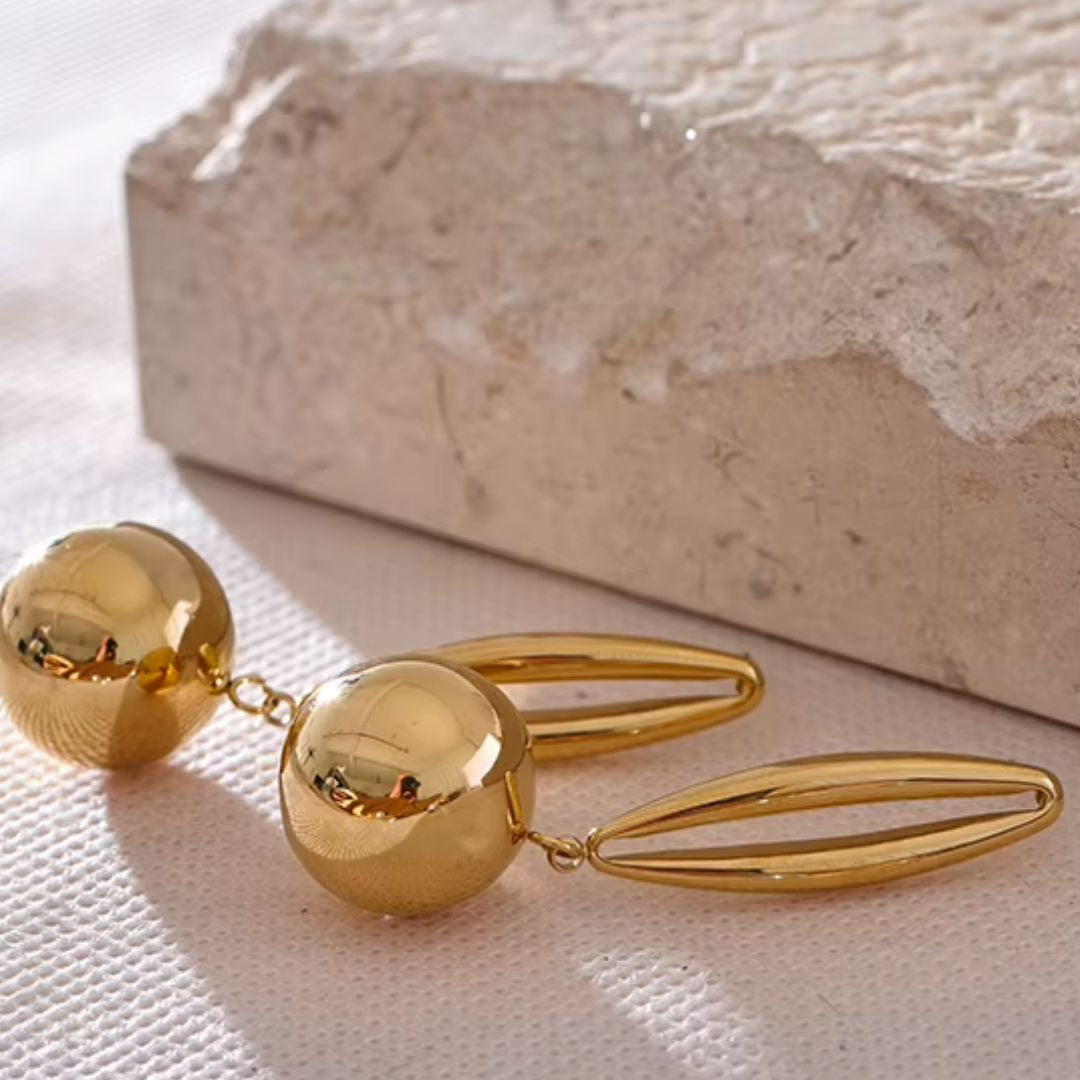 aretes colgantes, pendientes geométricos, aretes de gota oca, aretes en acero inoxidable, joyería dorada, pendientes en oro 18k, joyería elegante, aretes modernos, moda minimalista
https://lenorajewelry.com/aretes-colgantes-oro-18k-geometricos